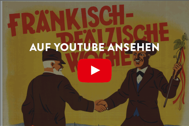 farbiges Plakat, das die fränkisch-pfälzische Woche im Jahr 1927 bewirbt: zwei gemalte Herren geben sich die Hände, im Hintergrund ist der Stadtplan von Mannheim zu sehen